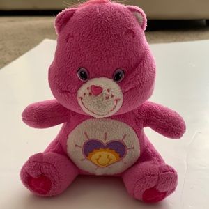 Shine Bright Carebear, with purple heart and sun in the middle 7 inches tall